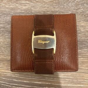 Ferragamo bifold wallet
Used condition 
No smell
See photos for tarnish and wear
